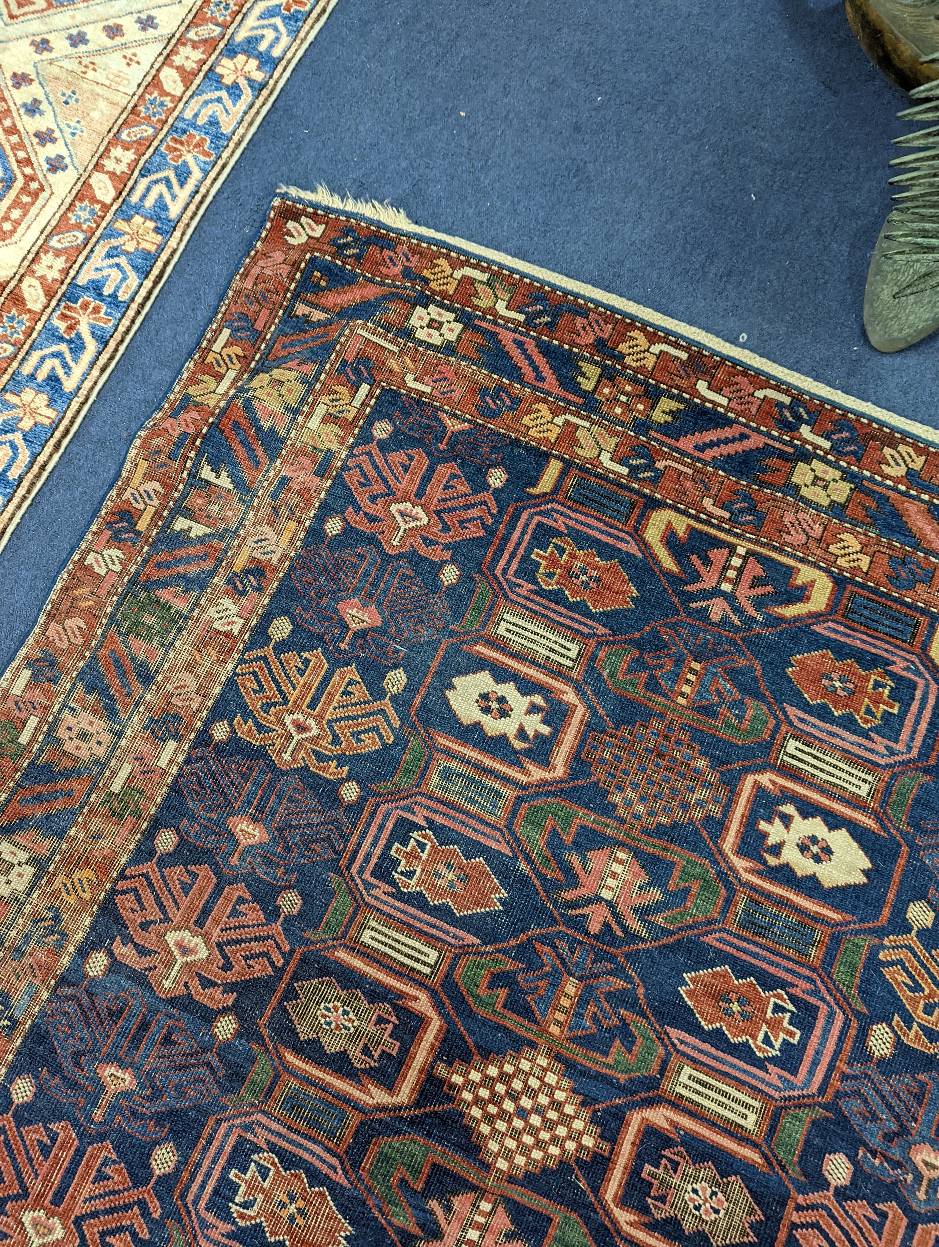 An antique Caucasian blue ground rug, 260 x 130cm